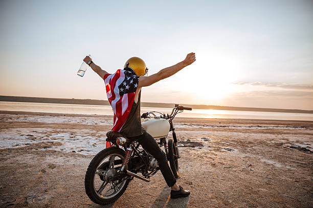 istock Man in american flag cape with hands up in air 595353338