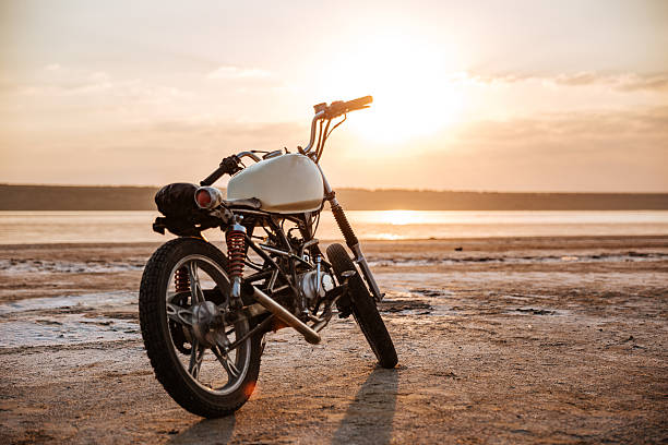 istock Retro motorcycle standing in the desert 595353536