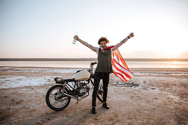 istock Man in american flag cape with hands up in air 595353778
