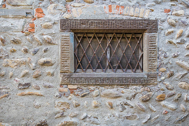 Old stones wall with bars window at the fort Old stones wall with bars window at the fort dungeon medieval prison prison cell stock pictures, royalty-free photos & images