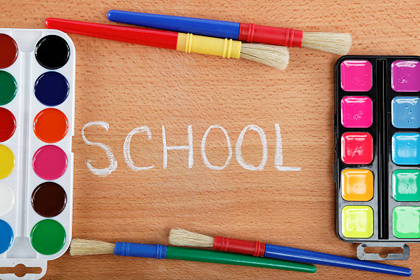 istock Paint and brushes on a wooden table. Back to school. 595357358
