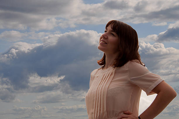 istock happy girl against the sky 595361546
