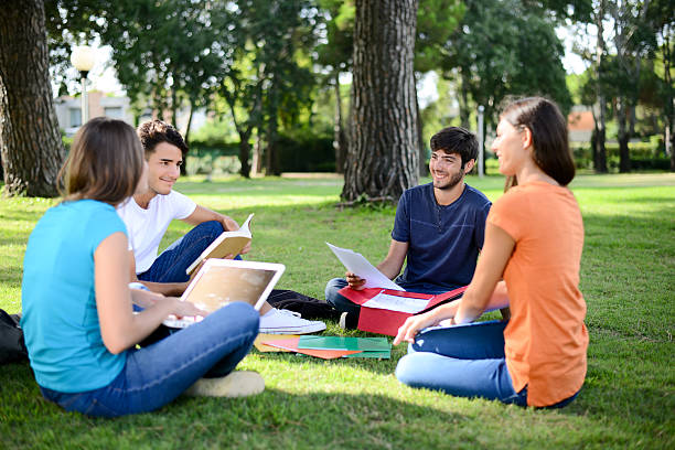 istock group students sitting together on lawn high school university campus 595361846