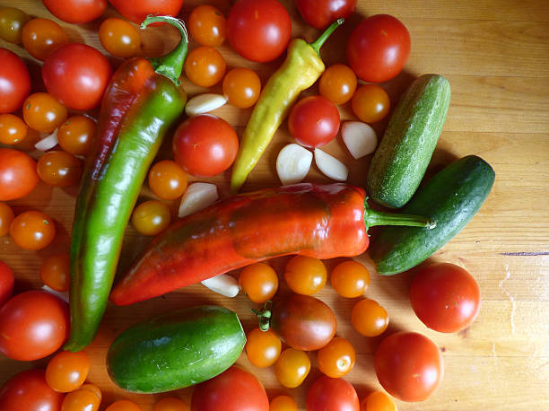 istock Tomatoes, cherry, cucumbers, garlic and peppers - vegetable background 595362400