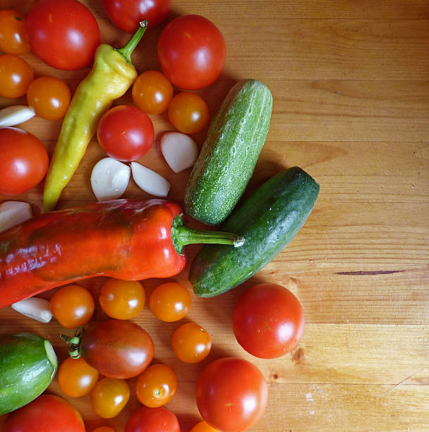 istock Tomatoes, cherry, cucumbers, garlic and peppers - vegetable background 595362936
