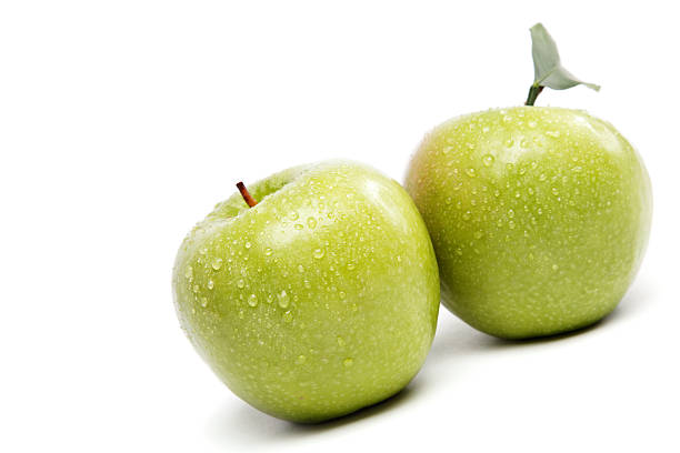 istock Green apples in drops of water. 595363104