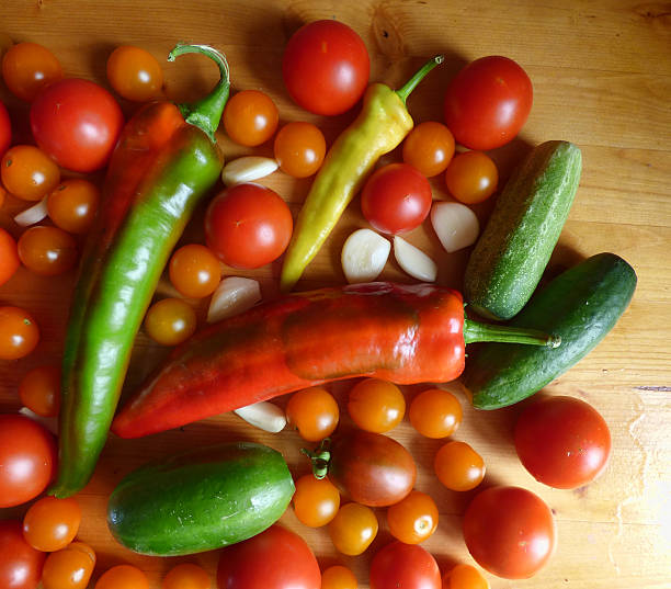 istock Tomatoes, cherry, cucumbers, garlic and peppers - vegetable background 595363124