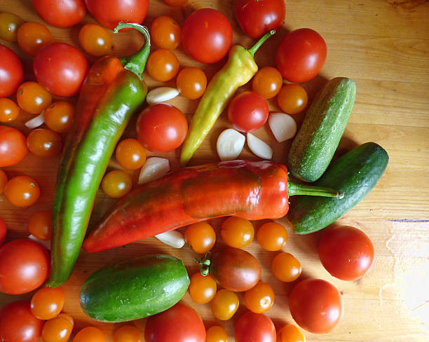 istock Tomatoes, cherry, cucumbers, garlic and peppers - vegetable background 595363154
