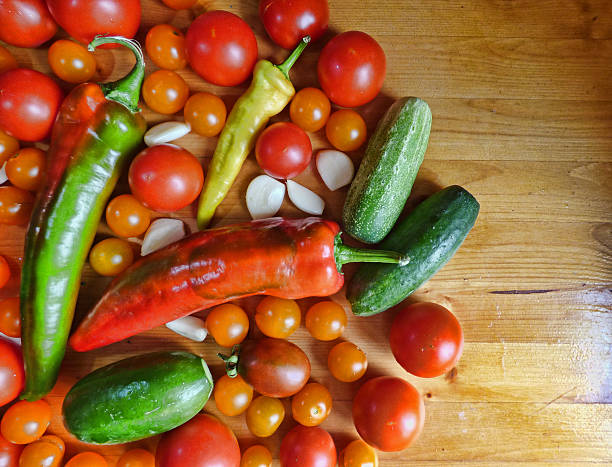 istock Tomatoes, cherry, cucumbers, garlic and peppers - vegetable background 595363388