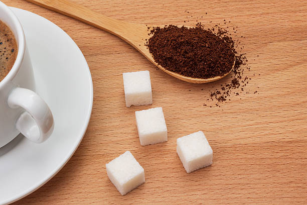 istock ground coffee in a wooden spoon on the table 595365382