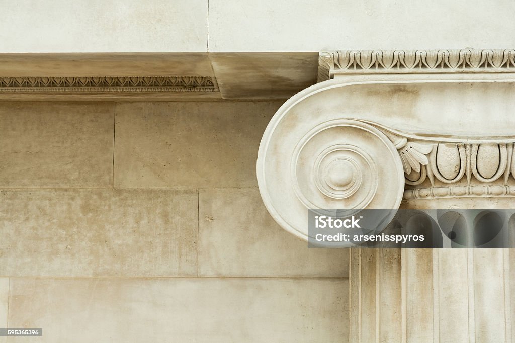 Decorative detail of an ancient Ionic column Decorative detail of an ancient Ionic column. close up. Architectural Column Stock Photo