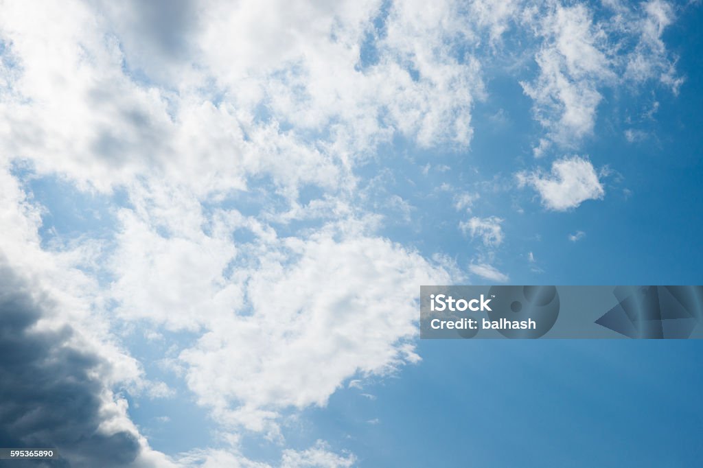 Partly cloudy sky Blue sky, white and gray clouds and diffused sunlight. Blue Stock Photo