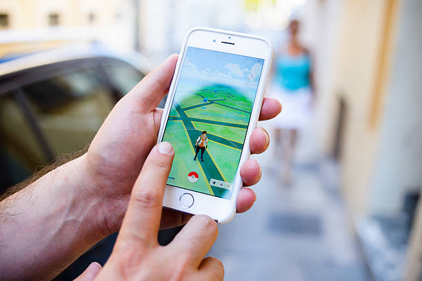 Antibes, France - August 24, 2016: A man plays Pokemon Go in the street.