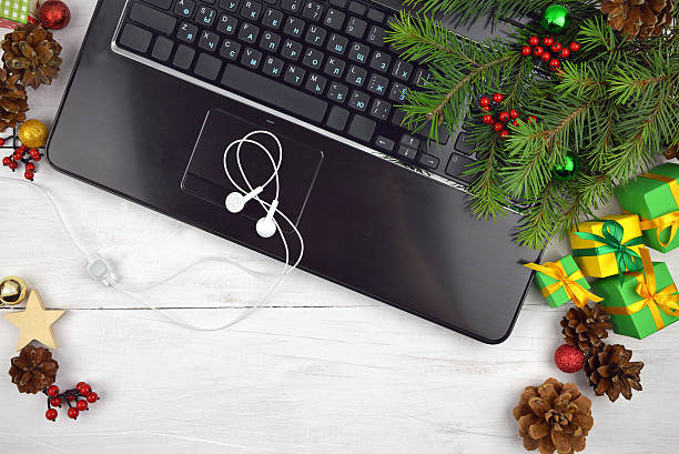 istock computer keyboard, headphones and celebratory tinsel on a wooden background, 595726028