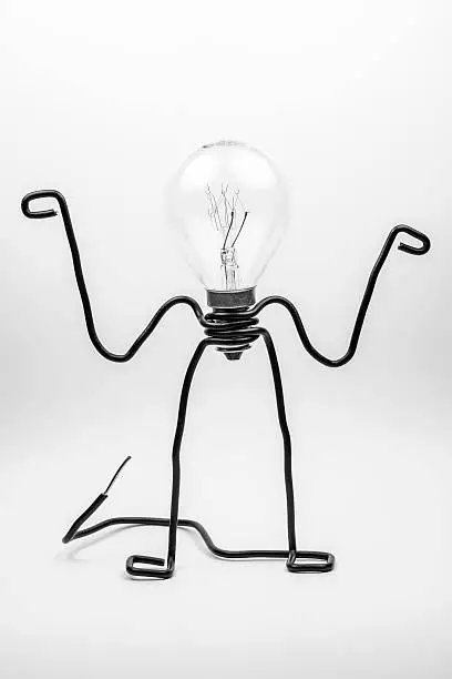 Emotional fantasy figure of a transparant light bulb and black electrical wires.