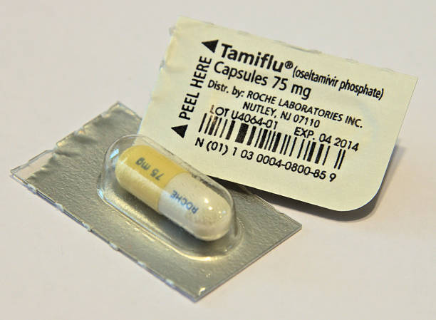 Expired Tamiflu Capsules Shreveport, Louisiana, USA - August 26, 2016: Close-up photo of the front and back of Tamiflu antiviral capsule packs with an expired expiration date. antiviral drug stock pictures, royalty-free photos & images