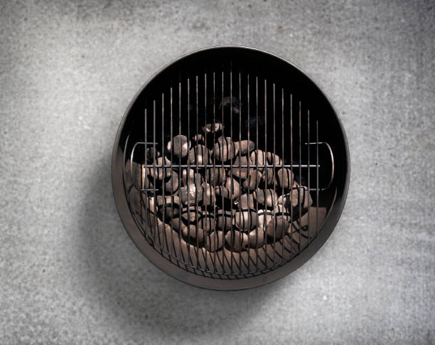 istock Charcoal BBQ on a Concrete Patio 595728162