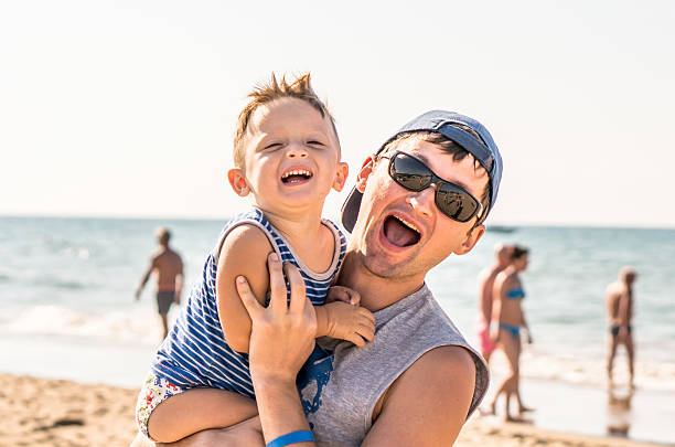 istock Father and baby son having fun on beach 595729230