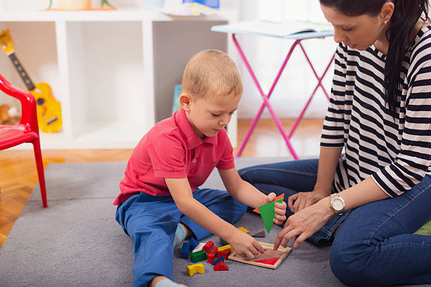 istock Child boy and mother playing with educational toy 595729298