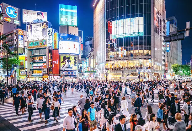 people walking across the Shibuya crossing in Tokyo, Japan