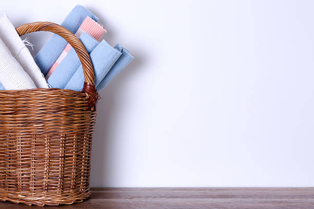 istock Worn Out Rugs in a Basket Against Empty White Wall 595732198