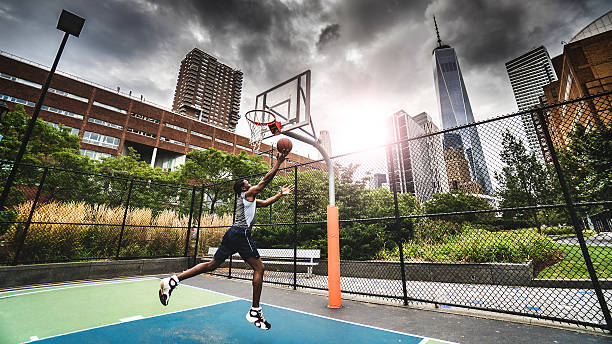 istock street basketball player doing a slam dunk 595732498
