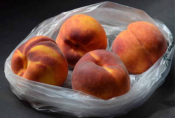 istock peaches in plastic grocery produce bag 595732754