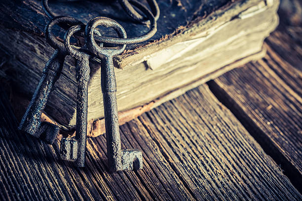 istock Vintage keys and books on old wooden table 595732924