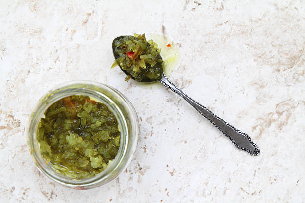 pickle relish in jar with spoonful on side - pickle relish imagens e fotografias de stock