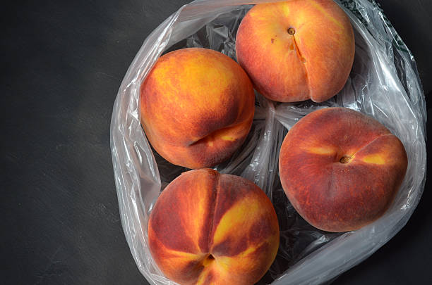 istock overhead view of peaches in plastic bag 595733522