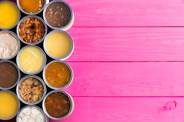 istock Open Cans of Soup on Bright Pink Background 595734882