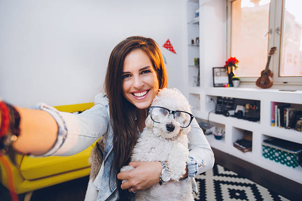 istock Selfie with cute little dog with eyeglasses 595737544