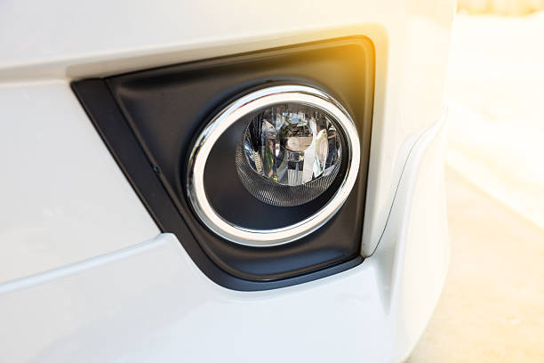 istock Closeup headlights of modern white car 595737660