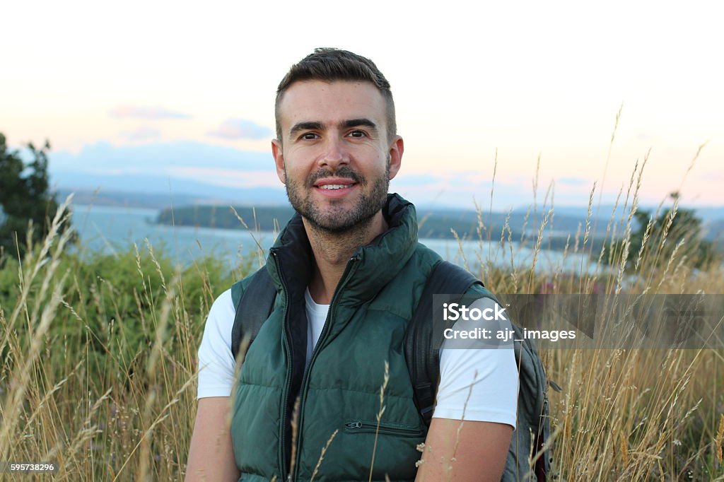 Handsome Natural Man Relaxing After Hiking Handsome Natural Man Relaxing After Hiking. Men Stock Photo