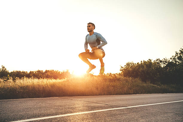 istock Athletic man exercising jumps outdoors 595738472