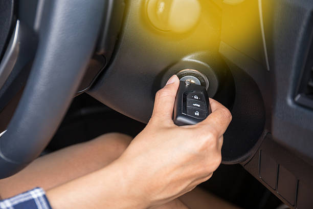 istock Women driver hand inserting car key and starting engine. 595738716