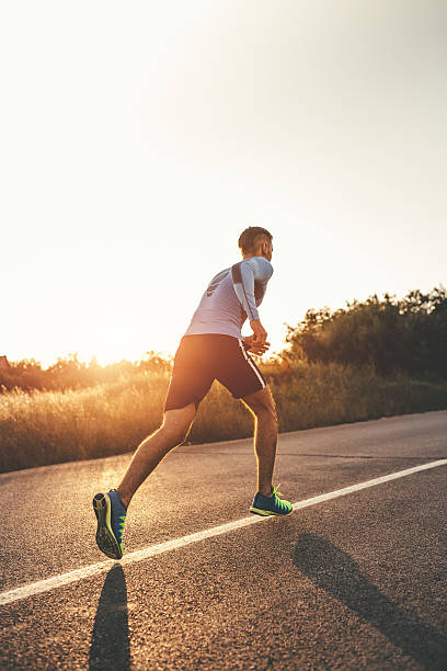 istock Fit young man running in sunset 595740166