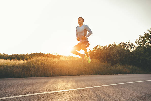 Athletic man exercising jumps outdoors