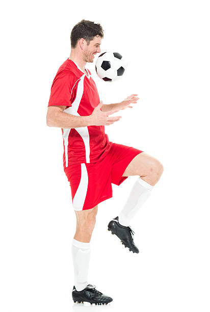 istock Smiling soccer player juggling 595744352