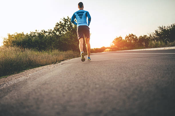 istock Fit young man running in sunset 595744568