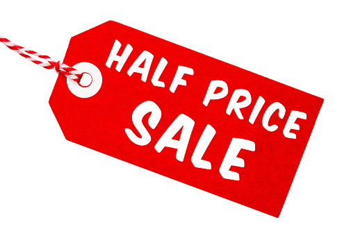 Half price sale tag made from recycled card with red and white string on an isolated white background with a clipping path
