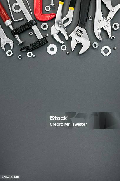 Various Clamps And Adjustable Wrenches On Grey Background Stock Photo - Download Image Now