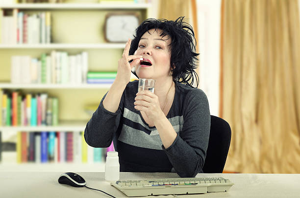 istock Female mature patient is ready to take a pill 595750764