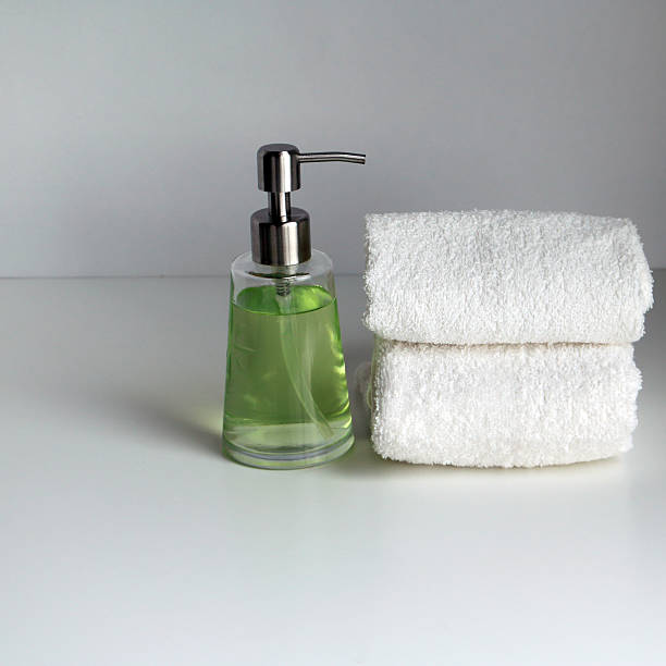 istock Two white loop towels and bottle with cosmetic product 595754436
