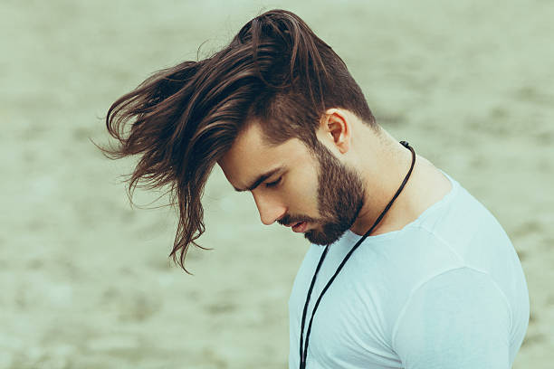 istock Portrait of a man with beard and modern hairstyle 595757876