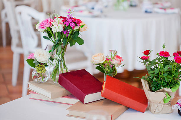 istock Wedding banquet, small restaurant. Floral decor in red, informal style. 595759156