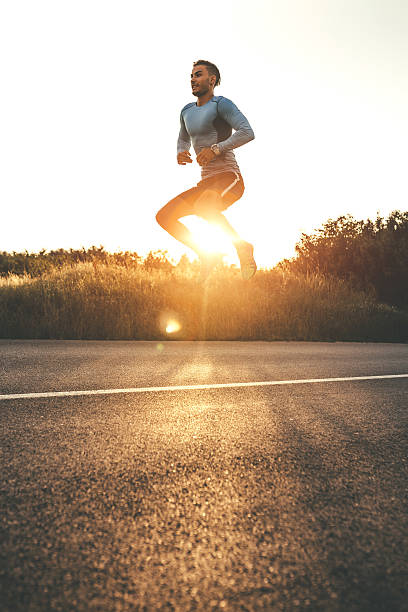 istock Athletic man exercising jumps outdoors 595761384