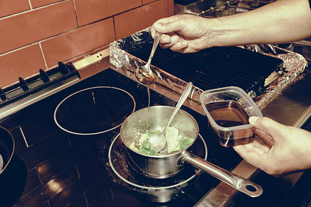istock Chef is cooking vegetables on stove, toned 595761740