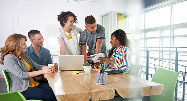 istock Multi ethnic group of succesful creative business people using a 595761768