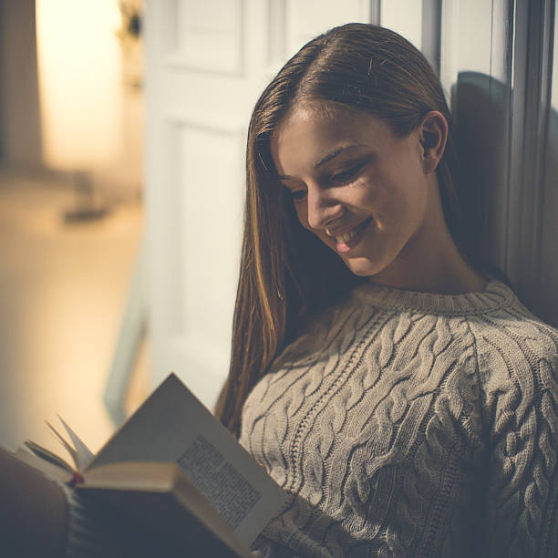 istock Reading a book in living room 595762164